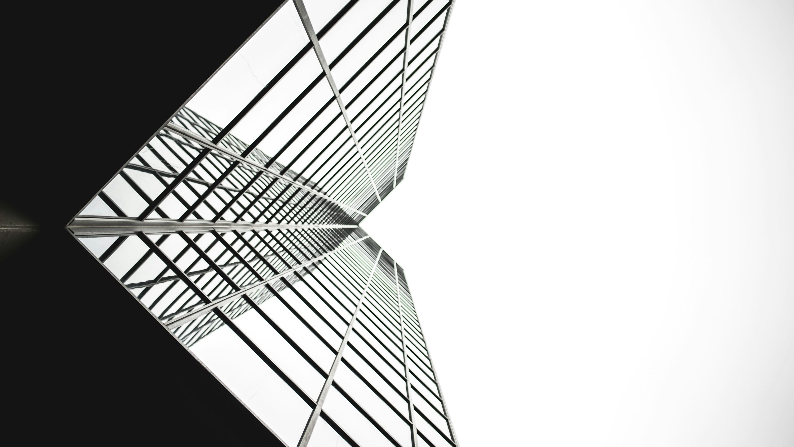 Systems optimisation - black and white glass building seen from below